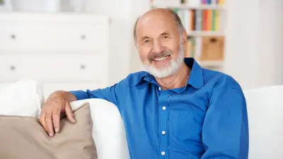A man is sitting on a couch.